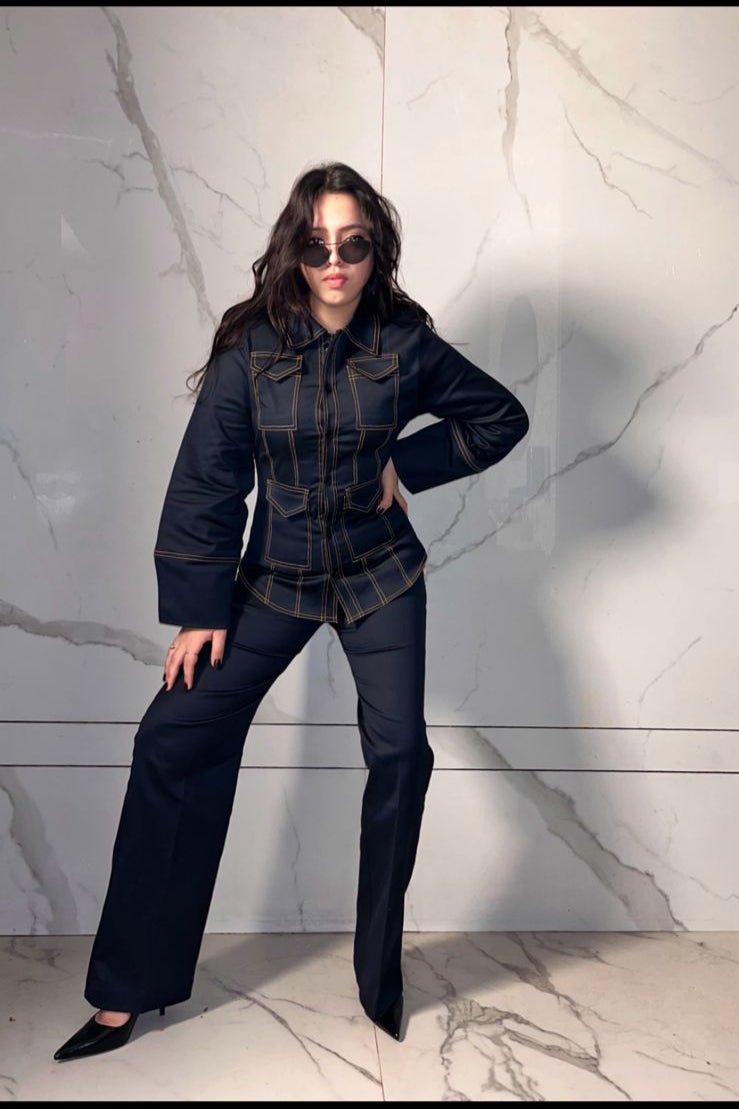 blue coat with bold double stitched and paired with high rise straight trousers 